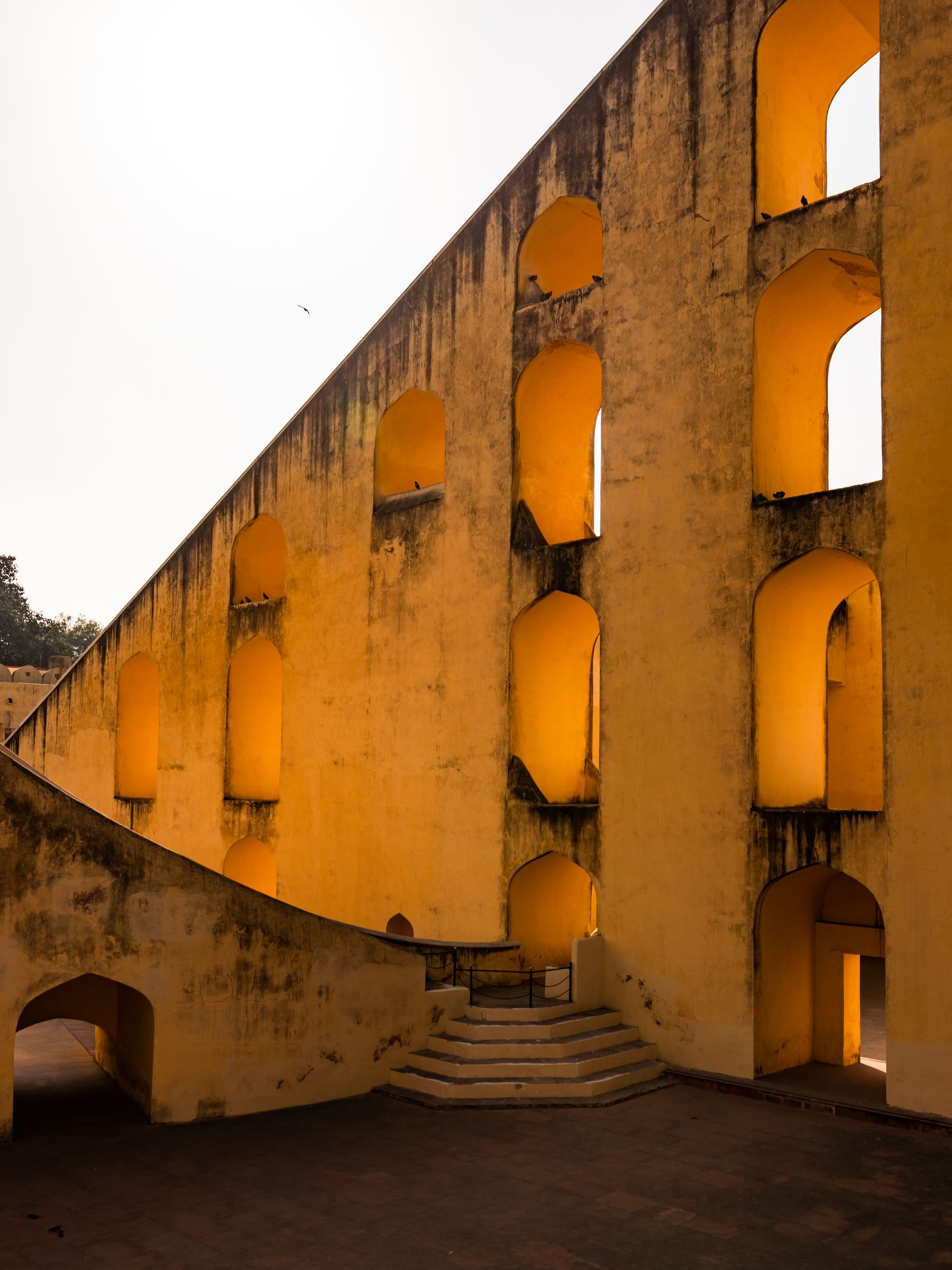 Curved Ochre Wall With Arched Openings